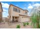 Beautiful stucco two-story home featuring a cozy front patio and a two-car garage at 1631 Desert Path Ave, North Las Vegas, NV 89032