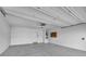 Clean and organized garage with ample storage space and a roll up door at 1631 Desert Path Ave, North Las Vegas, NV 89032