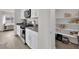 Well-lit kitchen with stainless steel appliances and adjoining pantry with storage shelves at 1631 Desert Path Ave, North Las Vegas, NV 89032