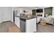 Modern kitchen features an island with gray countertops and stainless steel appliances at 1631 Desert Path Ave, North Las Vegas, NV 89032