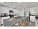 Modern kitchen with gray countertops, stainless steel appliances, and barstool seating at 1631 Desert Path Ave, North Las Vegas, NV 89032