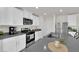 Bright kitchen boasts white cabinets, stainless steel appliances, and gray countertops at 1631 Desert Path Ave, North Las Vegas, NV 89032