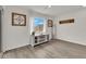 Bright living room with window, decorative wall hangings and light-colored flooring at 1631 Desert Path Ave, North Las Vegas, NV 89032