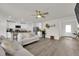 Open-concept living room and kitchen area featuring modern finishes and a ceiling fan at 1631 Desert Path Ave, North Las Vegas, NV 89032