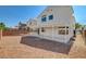Spacious backyard featuring a covered patio and low-maintenance gravel landscaping at 1716 Klamath Falls Way, Las Vegas, NV 89128