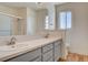 Bathroom features double sink vanity with modern fixtures and wood-look tile at 1716 Klamath Falls Way, Las Vegas, NV 89128