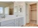 Modern bathroom features double sinks, quartz counters, and wood-look tile flooring at 1716 Klamath Falls Way, Las Vegas, NV 89128