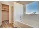 Bright bathroom with a large bathtub next to walk-in closet at 1716 Klamath Falls Way, Las Vegas, NV 89128