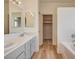 Bathroom featuring a double vanity, wood look flooring, and bright lighting at 1716 Klamath Falls Way, Las Vegas, NV 89128