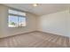 Bedroom with a large window and neutral-colored carpet at 1716 Klamath Falls Way, Las Vegas, NV 89128