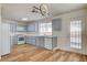 Well-lit kitchen features grey cabinets, white countertops, and wood-look flooring, offering a modern and functional cooking space at 1716 Klamath Falls Way, Las Vegas, NV 89128