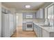 Bright kitchen features stainless appliances, gray cabinets, and wood-look flooring at 1716 Klamath Falls Way, Las Vegas, NV 89128