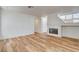 Cozy living room with wood-look floors, a fireplace, and ample natural light, ideal for relaxation and entertainment at 1716 Klamath Falls Way, Las Vegas, NV 89128