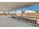 Large covered patio with a white railing overlooking the backyard at 1716 Klamath Falls Way, Las Vegas, NV 89128