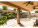 Inviting back patio with a covered area and beautiful landscaping at 1779 Antelope Valley Ave, Henderson, NV 89012