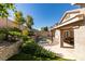 Landscaped backyard featuring a built-in stone wall and a private pool at 1779 Antelope Valley Ave, Henderson, NV 89012