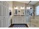 Bathroom featuring double sinks, granite counters, glass shower, and decorative tile work at 1779 Antelope Valley Ave, Henderson, NV 89012