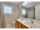 Bathroom with double sinks, wood cabinets, a large mirror, and a shower-tub combination at 1779 Antelope Valley Ave, Henderson, NV 89012