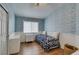 Cozy bedroom with sky-themed wallpaper, wood floors, and a white metal-frame bed at 1779 Antelope Valley Ave, Henderson, NV 89012