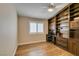 Bedroom with wood floors, a built-in desk with cabinets, and a large window at 1779 Antelope Valley Ave, Henderson, NV 89012