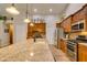 Spacious kitchen features stainless appliances, wood cabinets, and granite countertops at 1779 Antelope Valley Ave, Henderson, NV 89012