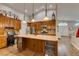 Bright kitchen featuring an island with wooden cabinets, granite countertops, and stainless steel appliances at 1779 Antelope Valley Ave, Henderson, NV 89012