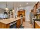 Bright kitchen featuring stainless steel appliances, wooden cabinets, granite countertops and a breakfast nook at 1779 Antelope Valley Ave, Henderson, NV 89012