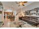 Bright living room with wood floors, a cozy sofa, and open floor plan to the kitchen and dining area at 1779 Antelope Valley Ave, Henderson, NV 89012