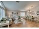Cozy living and dining space featuring shuttered windows and modern chandelier at 1779 Antelope Valley Ave, Henderson, NV 89012