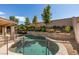Inviting pool and spa surrounded by mature trees and lush landscaping at 1779 Antelope Valley Ave, Henderson, NV 89012