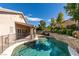 Backyard with pristine pool, rock waterfall, and lush landscaping at 1779 Antelope Valley Ave, Henderson, NV 89012