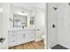 Bright bathroom featuring a sleek white vanity, modern fixtures, and a walk-in shower with marbled tile at 2112 Hollow Oak Ave, North Las Vegas, NV 89031