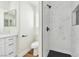 Modern bathroom showcasing a walk-in shower with marbled tile and black fixtures plus modern vanity at 2112 Hollow Oak Ave, North Las Vegas, NV 89031