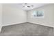 Spacious bedroom with plush gray carpet, ceiling fan and window at 2112 Hollow Oak Ave, North Las Vegas, NV 89031