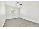 Bedroom featuring gray carpet, a ceiling fan, and a view to the exterior at 2112 Hollow Oak Ave, North Las Vegas, NV 89031