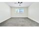 Neutral bedroom featuring plush gray carpet, ceiling fan and one window at 2112 Hollow Oak Ave, North Las Vegas, NV 89031