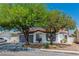Charming single-story home with a well-maintained front yard and mature trees offering shade and curb appeal at 2112 Hollow Oak Ave, North Las Vegas, NV 89031