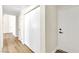 Long hallway with wood-look floors and bright white doors at 2112 Hollow Oak Ave, North Las Vegas, NV 89031