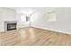 Open-concept living space with wood-look floors, bright natural light and a cozy fireplace at 2112 Hollow Oak Ave, North Las Vegas, NV 89031