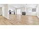 Spacious open-concept area featuring wood-look floors, connecting the living area to the kitchen at 2112 Hollow Oak Ave, North Las Vegas, NV 89031