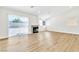 Well-lit living room with wood-look floors, neutral paint, sliding glass doors and a modern fireplace at 2112 Hollow Oak Ave, North Las Vegas, NV 89031