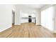 Bright living room boasts wood floors, an open floorplan, and access to the kitchen at 2112 Hollow Oak Ave, North Las Vegas, NV 89031
