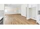 Bright open-concept living room with wood-look floors connects to kitchen and entry at 2112 Hollow Oak Ave, North Las Vegas, NV 89031