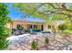 Spacious backyard with a covered patio, outdoor seating, and meticulously landscaped garden areas at 2205 Sandstone Cliffs Dr, Henderson, NV 89044