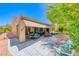 Beautiful backyard featuring a covered patio with outdoor seating and a well-manicured garden at 2205 Sandstone Cliffs Dr, Henderson, NV 89044
