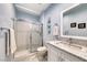 Well-lit bathroom with a glass-enclosed shower, granite countertops, and updated fixtures at 2205 Sandstone Cliffs Dr, Henderson, NV 89044