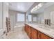 Bathroom with granite countertops, double sinks, tub, and glass shower at 2205 Sandstone Cliffs Dr, Henderson, NV 89044