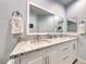 Bright bathroom featuring double sinks with granite countertops and a large mirror at 2205 Sandstone Cliffs Dr, Henderson, NV 89044