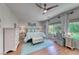 Bright bedroom with light wood floors, light blue accents, and backyard views at 2205 Sandstone Cliffs Dr, Henderson, NV 89044