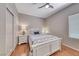 Charming bedroom featuring a white bed frame and coastal-themed bedding, with a ceiling fan and closet at 2205 Sandstone Cliffs Dr, Henderson, NV 89044